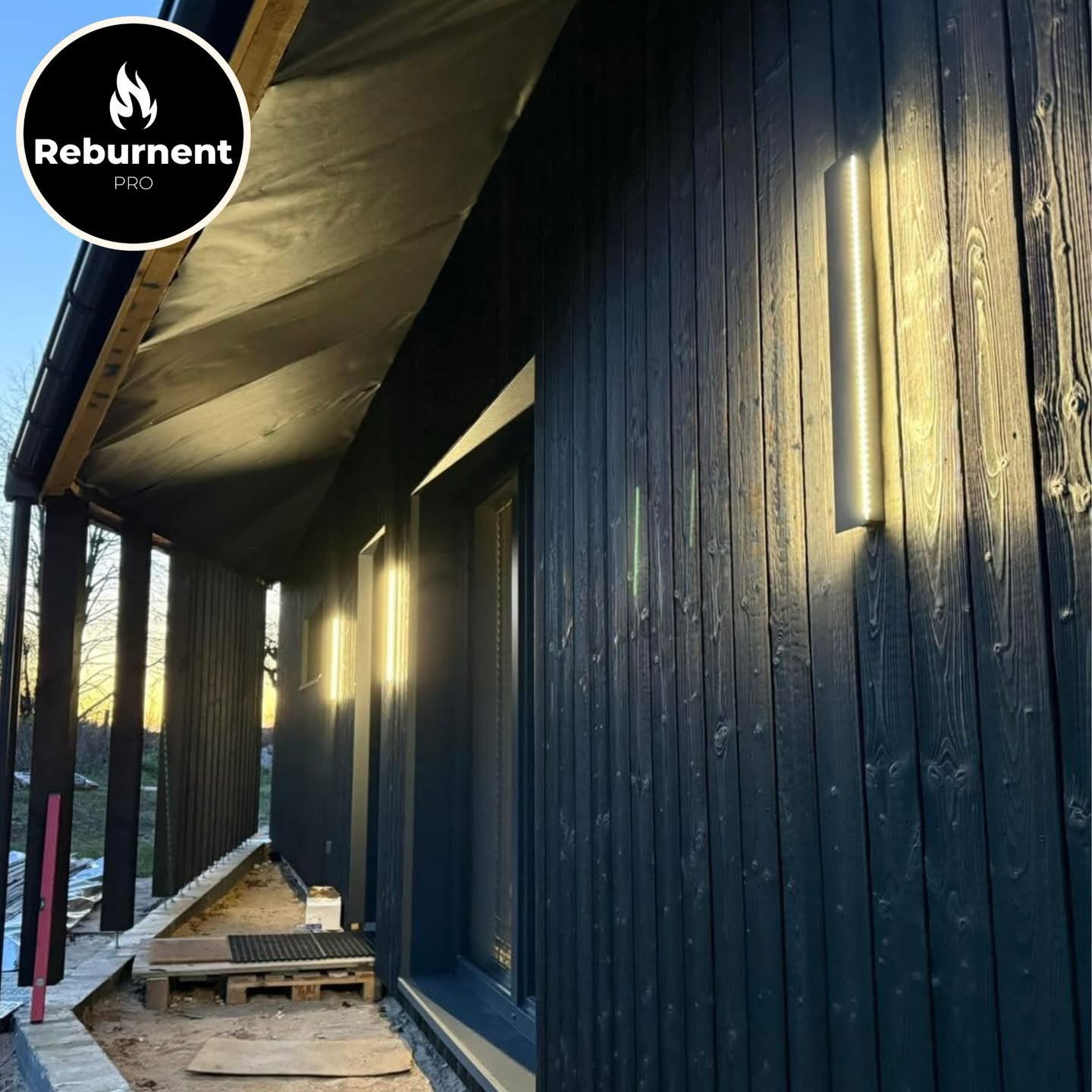 Charred cladding terrace with exterior lighting at dusk
