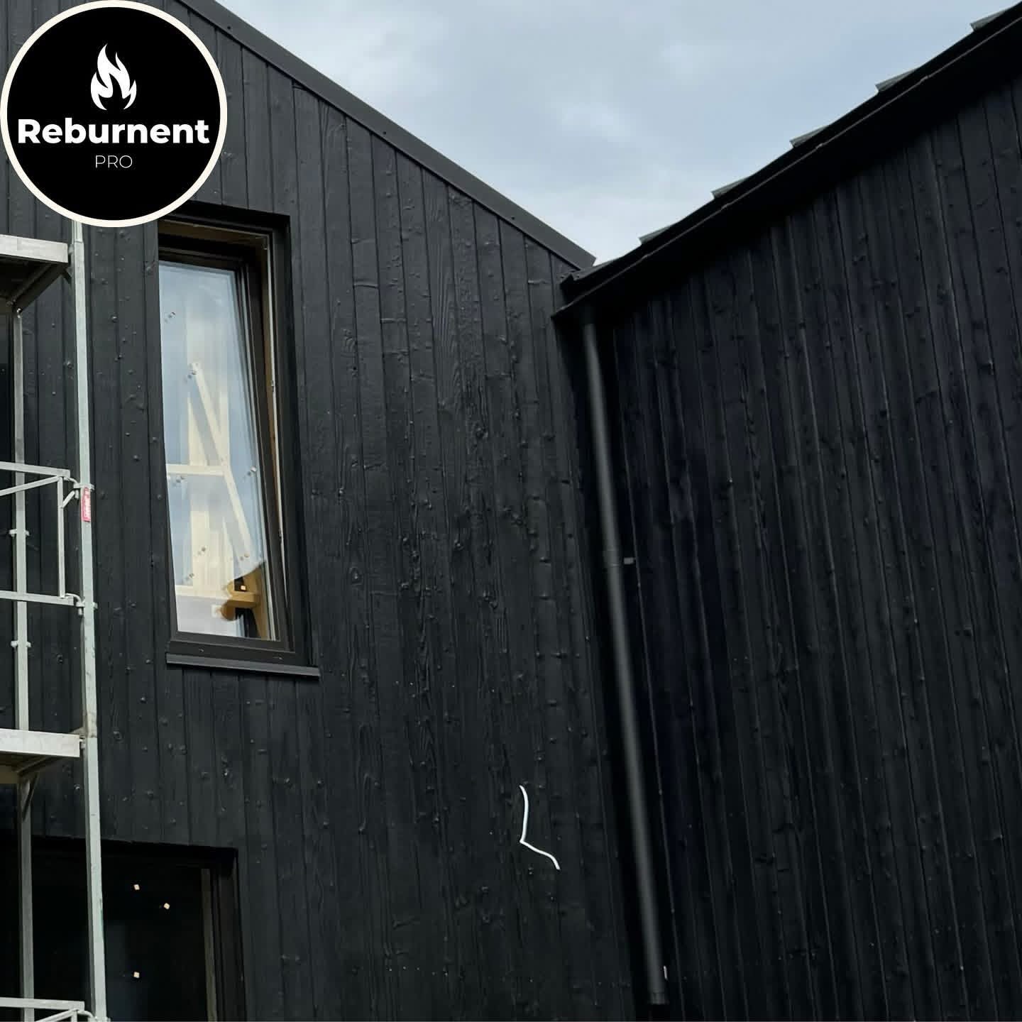 Deep black charred cladding on twin gable facades
