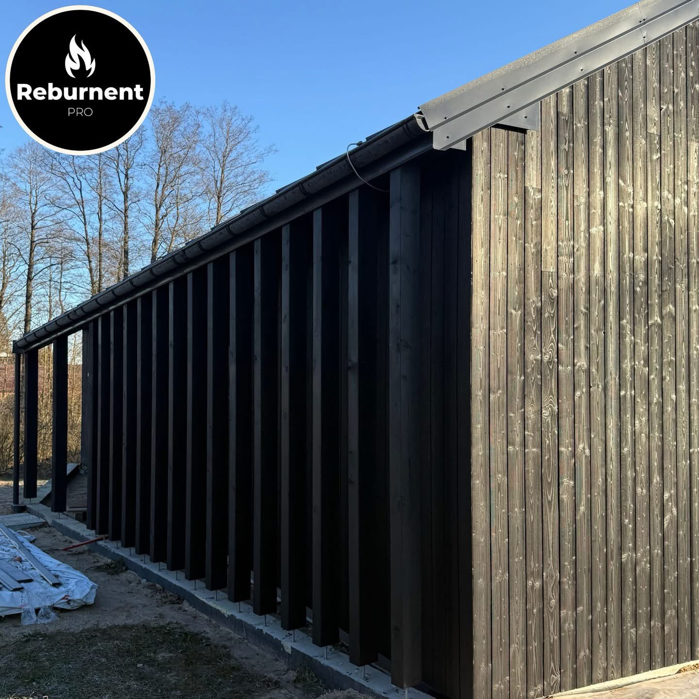Long charred timber facade with covered walkway