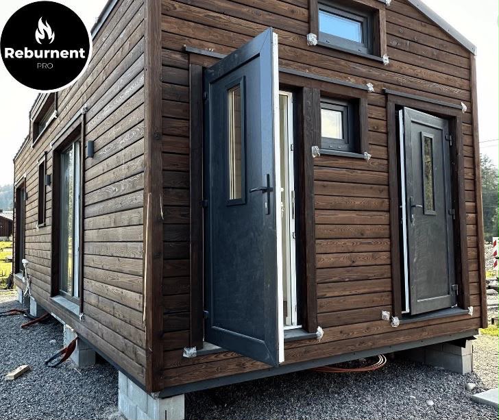 Charred timber modular building exterior with dark doors